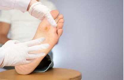 podiatrist gently examining a senior patients foot during an in-home podiatry visit