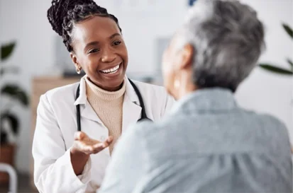 podiatrist reviewing medical documents with a patient during a home visit consultation